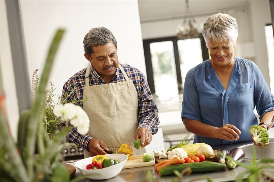 Older couple cooking together.