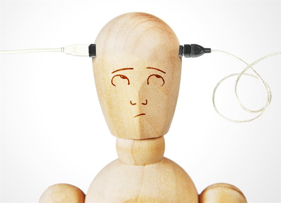 Wooden figure of person with wires going into head.