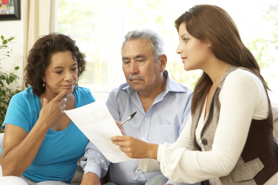 Older couple talking with health promoter.