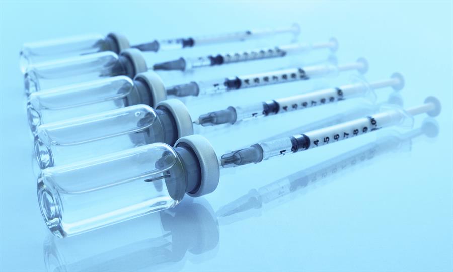 Flu vaccination needles and viles of medicine.