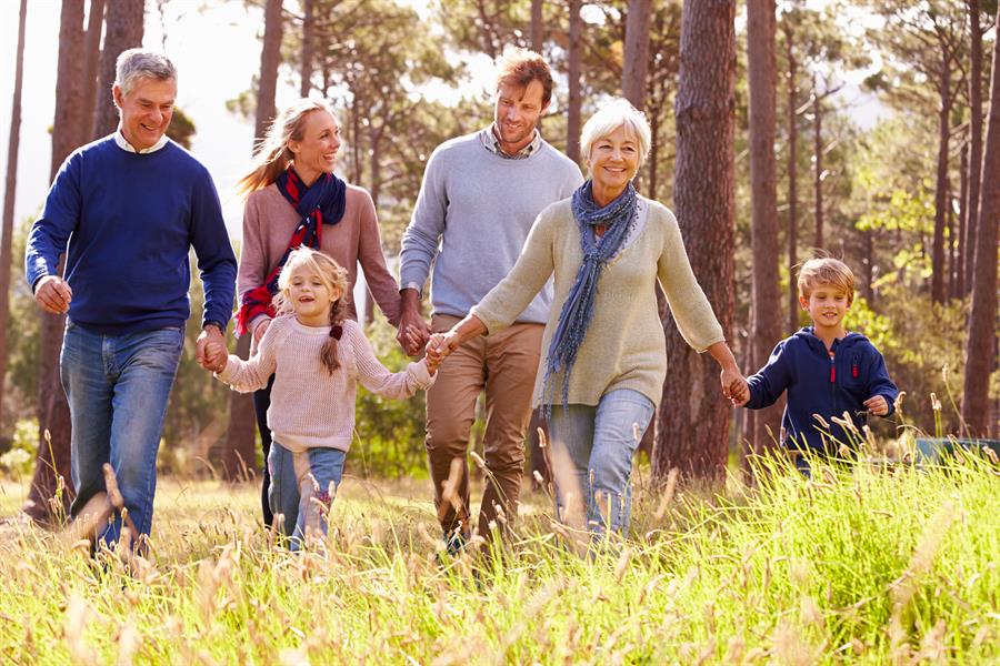 Happy multi-generation family walking in the countryside.