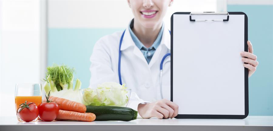 Doctor with vegetables and checklist.