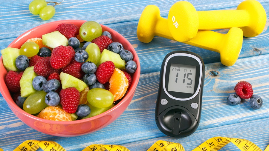 Fresh fruit salad, glucose meter and centimeter, diabetes, healthy lifestyle and nutrition concept