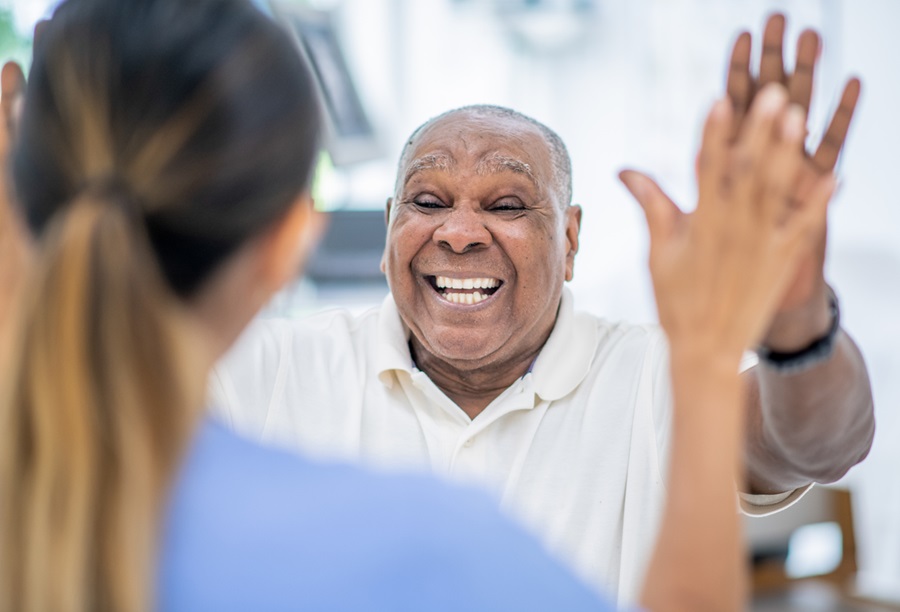 Older adult celebrating with health care provider