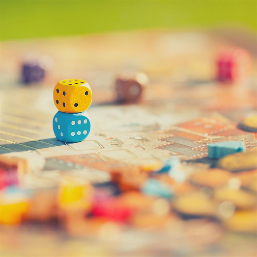 Closeup of dice ontop of a board game.